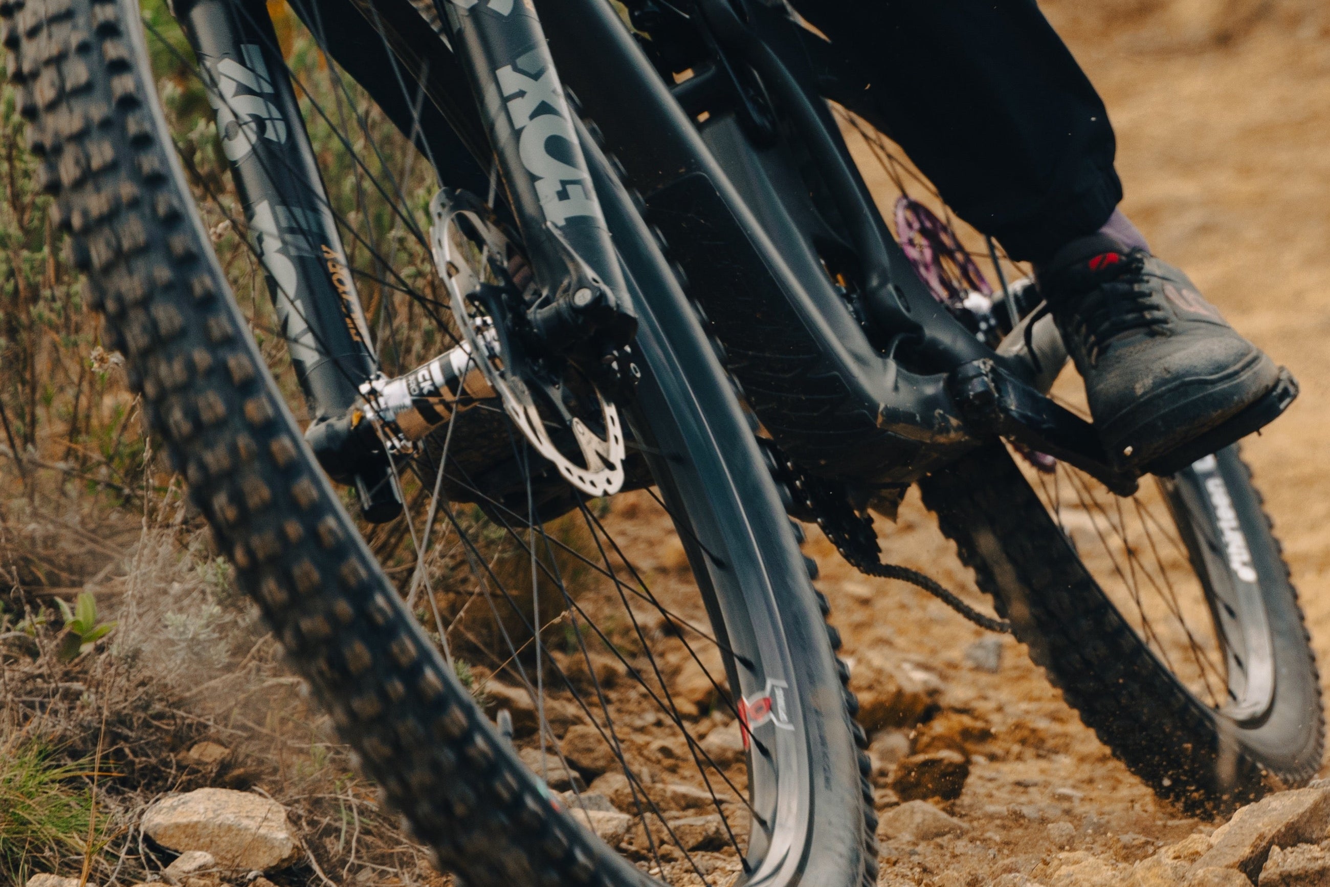 A Grappler tire cornering on a loose trail