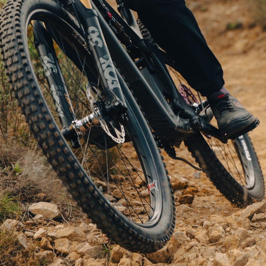 A Grappler tire cornering on a loose trail