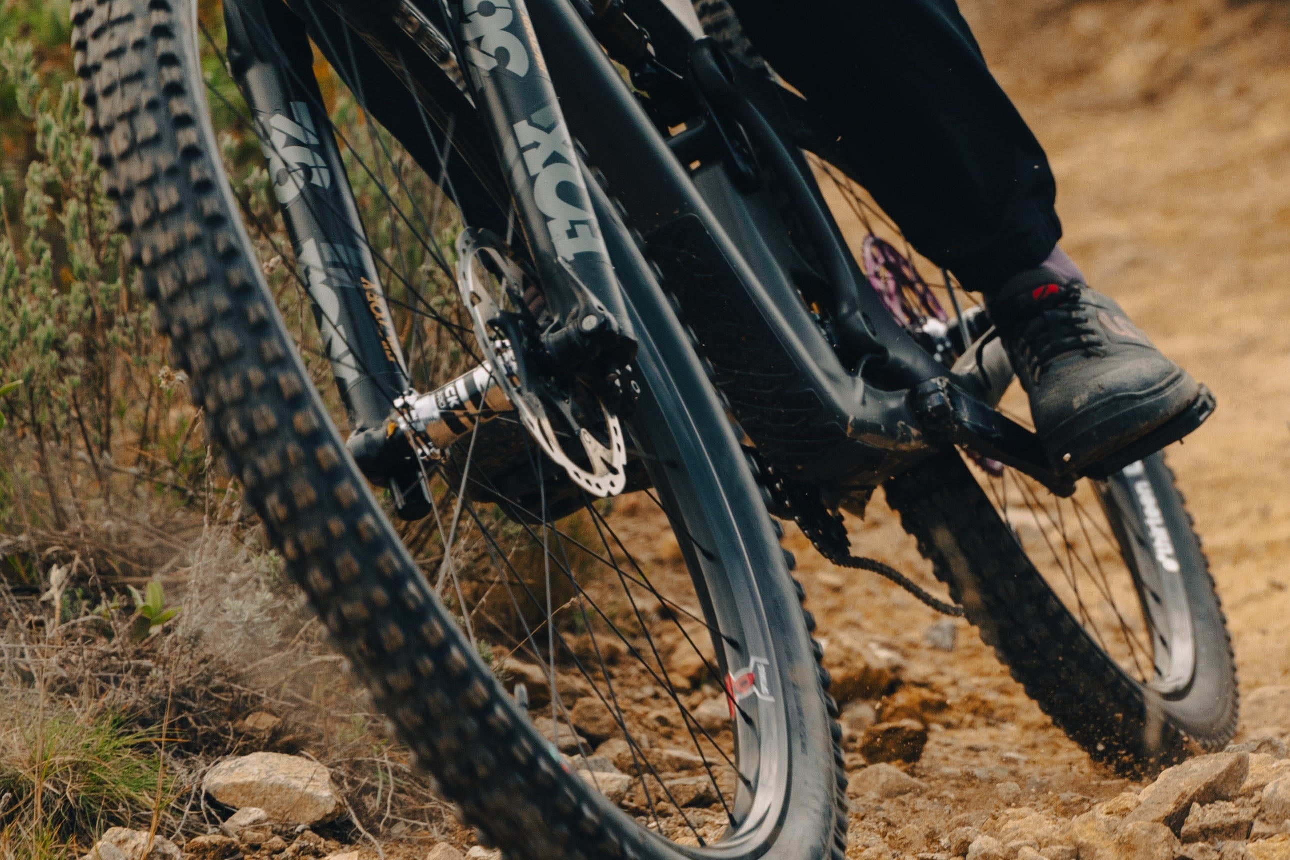 A Grappler Radial tire on a rider's bike on a dry trail