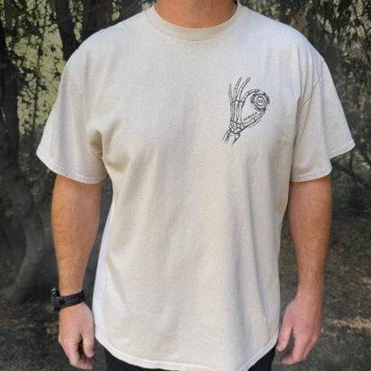 Front of the Zen Reaper T-shirt in Sand with a skeleton hand holding the magic on the left chest