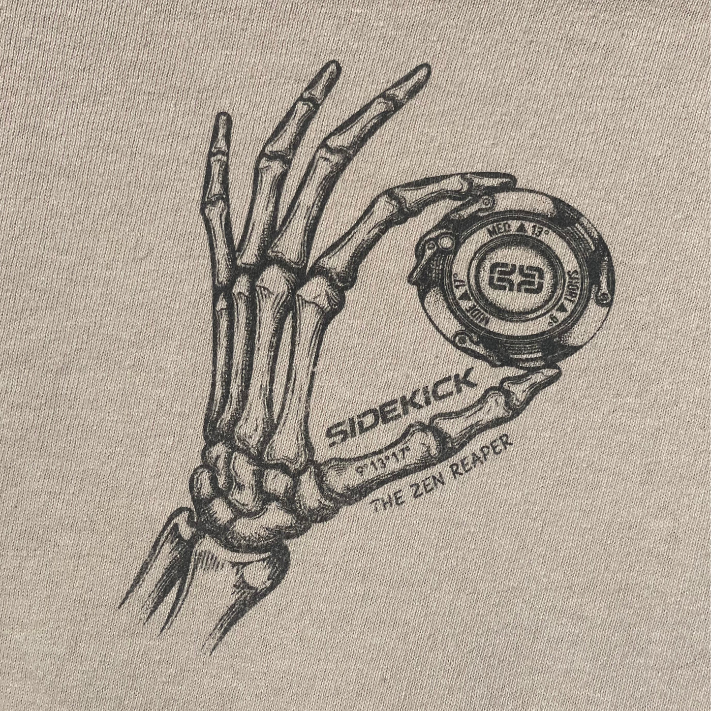 Close-up of the chest print: a skeleton hand holding the magic, with Sidekick and The Zen Reaper lettering e*thirteen