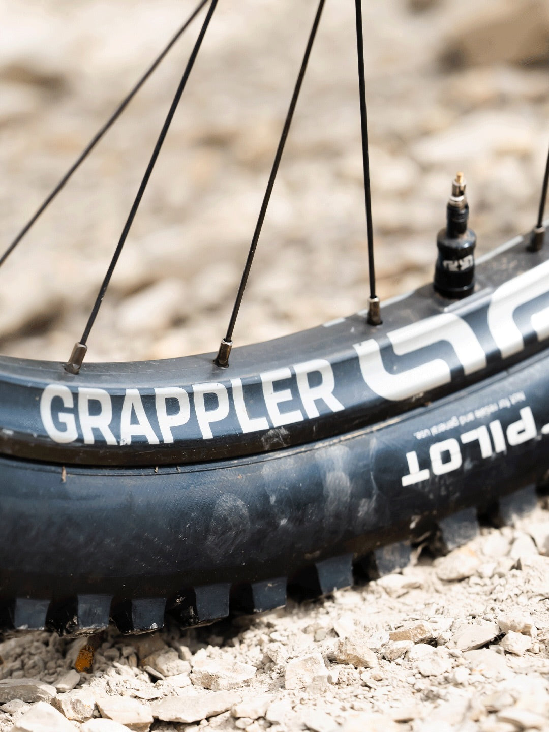 Close up of a Grappler Flux carbon rim and tubeless valve on Alex Rudeau's Meta SX Power 800