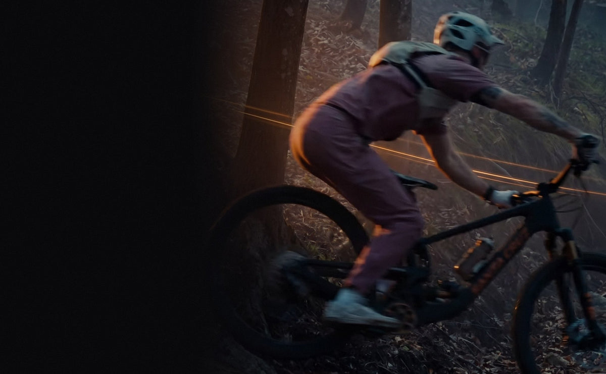 Rider on a black and bronze bike in a dark forest, Dark Mode sale
