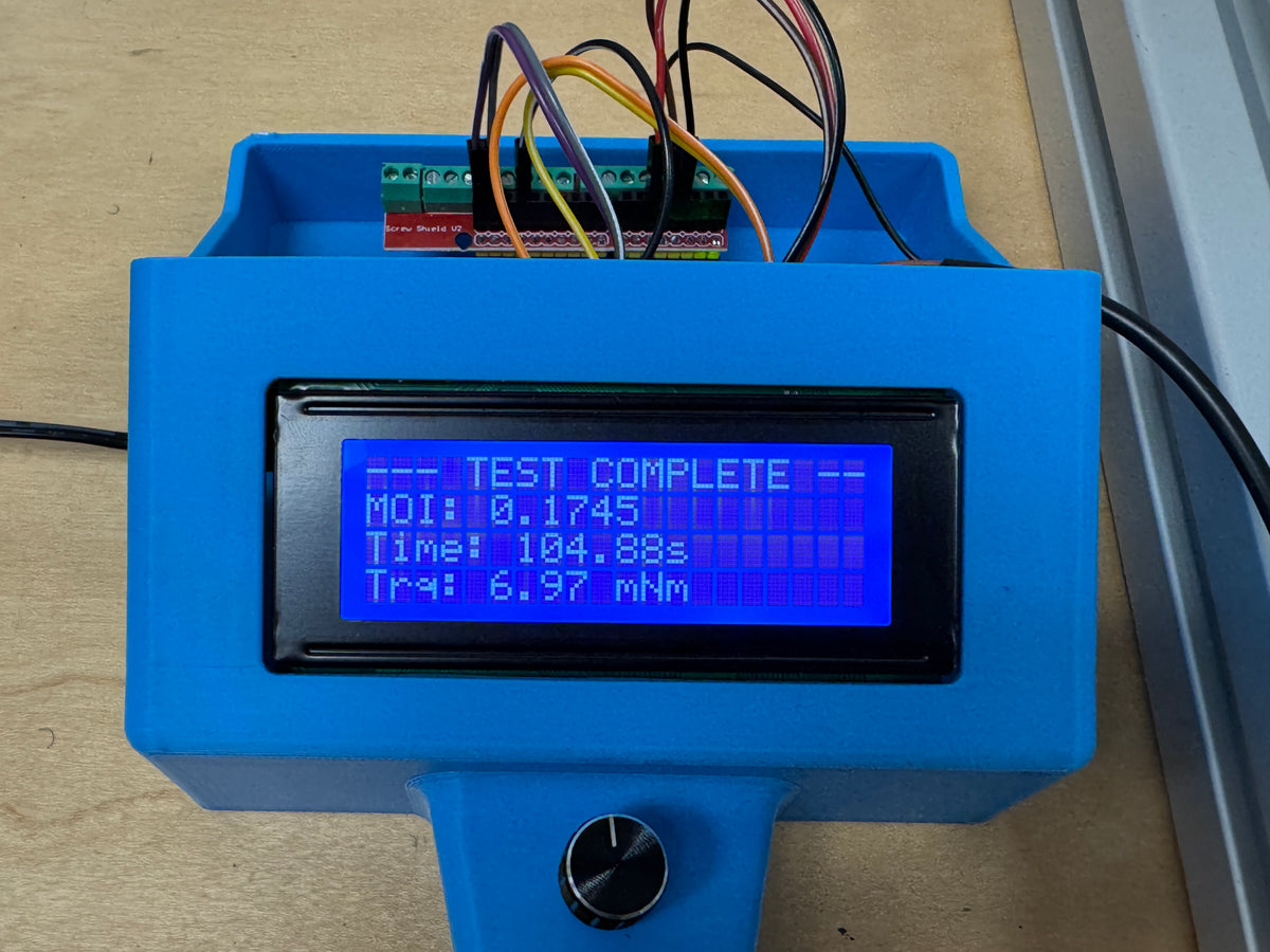 The data logger reading TEST COMPLETE, with the spin-down time and drag torque from a single run.