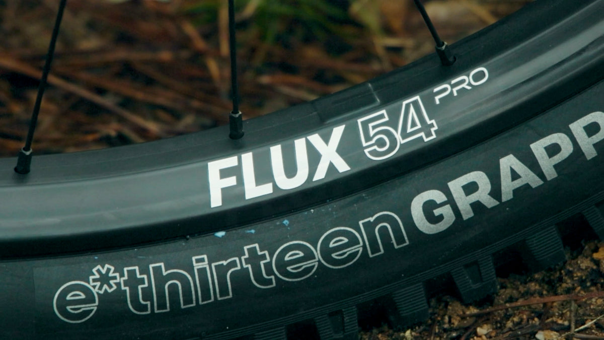 Close-up of a Flux 54 Pro carbon rim with an e*thirteen Grappler tire mounted.