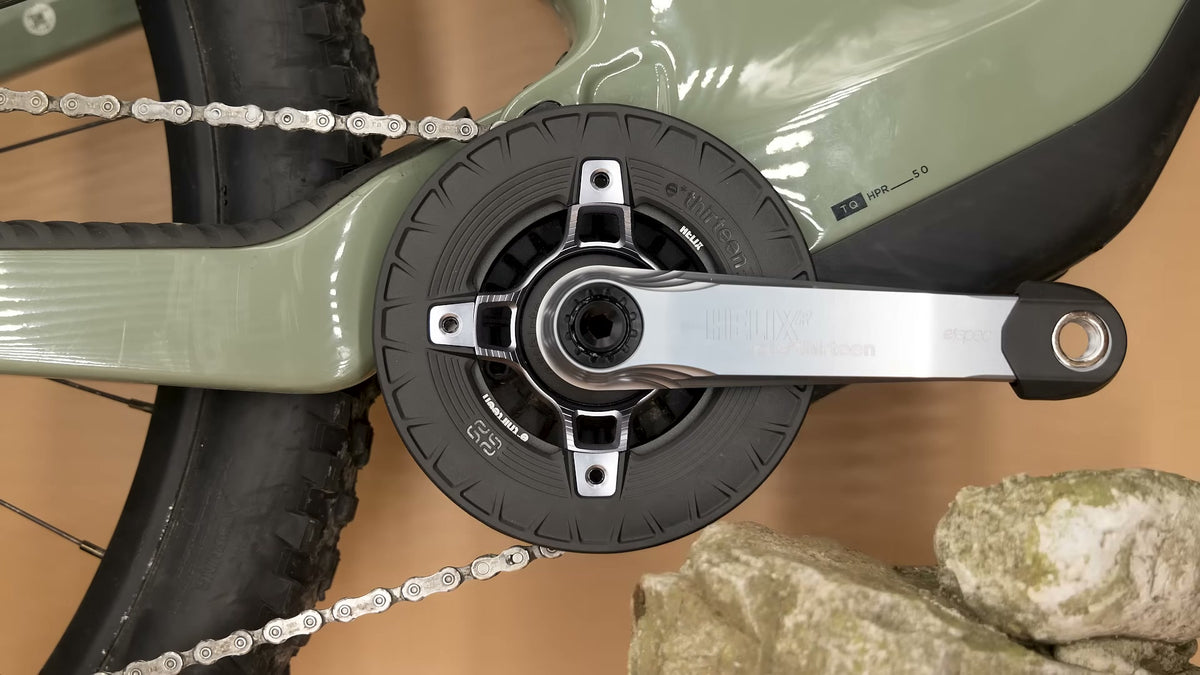 A Turbocharger fitted to a Scott E-MTB with a TQ motor, a rock sitting right beside the bashguard.